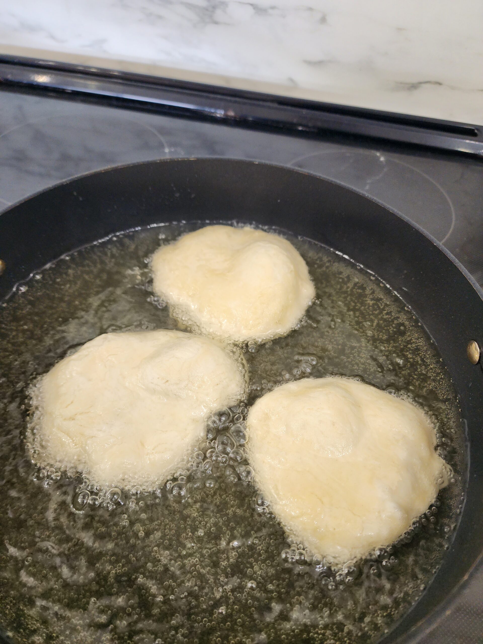 johnny cakes frying in oil